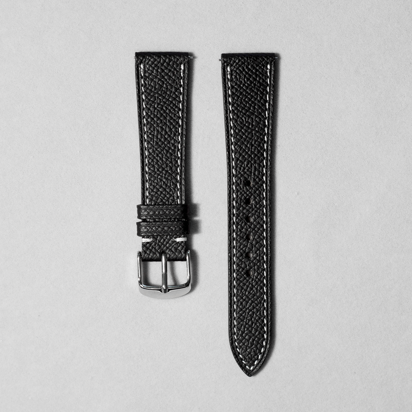 Handcrafted epsom leather watch strap in black with white stitching. Comes with quick release spring bar. available in 17-20 mm lug widths.