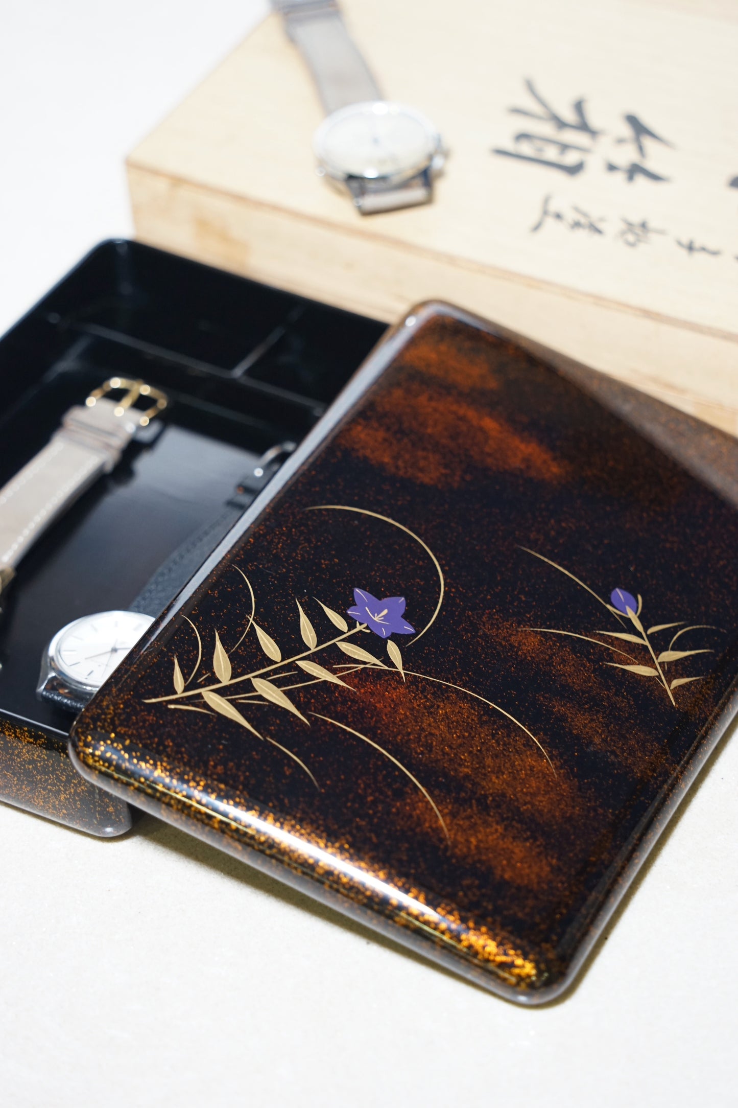 Decorative japanese urushi box with floral design on a white surface