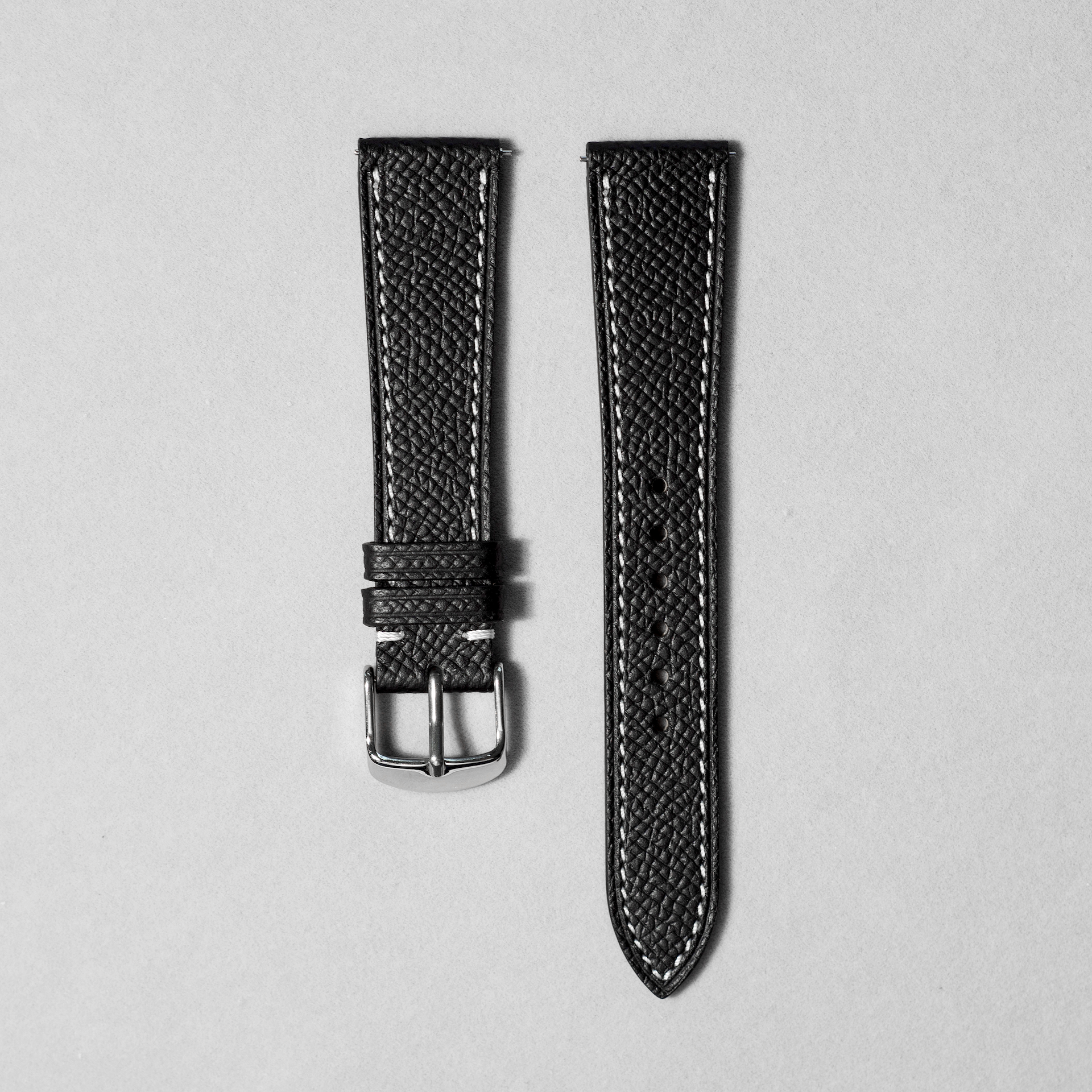 Handcrafted epsom leather watch strap in black with white stitching. Comes with quick release spring bar. available in 17-20 mm lug widths. 
